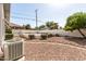Spacious backyard featuring rock landscaping and privacy hedges at 1837 E Presidio Rd, Phoenix, AZ 85022