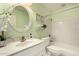 Bright bathroom features a white vanity, decorative mirror, and a shower-tub combination at 1837 E Presidio Rd, Phoenix, AZ 85022