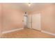 Simple bedroom with light hardwood floors, closet and connecting door to a possible ensuite at 1837 E Presidio Rd, Phoenix, AZ 85022