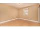 Spare bedroom, simply furnished with light hardwood floors and a large window for natural light at 1837 E Presidio Rd, Phoenix, AZ 85022