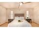 Inviting bedroom featuring a ceiling fan, side tables, and serene decor with floral accents on the wall at 1837 E Presidio Rd, Phoenix, AZ 85022