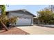 Inviting home featuring an attached garage, mature trees, and a well-maintained driveway at 1837 E Presidio Rd, Phoenix, AZ 85022
