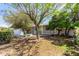 Home's front yard features mature trees and a quaint bench at 1837 E Presidio Rd, Phoenix, AZ 85022