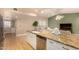 Bright kitchen featuring granite countertops, stainless steel dishwasher, and open concept to the living area at 1837 E Presidio Rd, Phoenix, AZ 85022