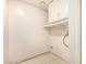 Well-lit laundry room has upper cabinets and some shelving at 1837 E Presidio Rd, Phoenix, AZ 85022