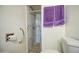 Updated bathroom featuring marble tile shower, grab bar, and modern fixtures at 1849 E Jarvis Ave, Mesa, AZ 85204
