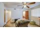 Bedroom featuring a ceiling fan, vinyl flooring, with an open view into the bathroom at 1849 E Jarvis Ave, Mesa, AZ 85204
