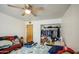 Cluttered bedroom with a full closet and basic furnishings under a ceiling fan at 1849 E Jarvis Ave, Mesa, AZ 85204