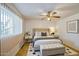Cozy bedroom featuring a ceiling fan, comfortable queen bed and modern minimalist decor at 1849 E Jarvis Ave, Mesa, AZ 85204