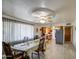 Bright dining room with a large window, ceiling fan, and an adjacent view of the kitchen at 1849 E Jarvis Ave, Mesa, AZ 85204