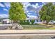 Charming single-story home with a well-maintained front yard, mature trees and sidewalk at 1849 E Jarvis Ave, Mesa, AZ 85204