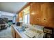 Kitchen interior featuring a stainless-steel sink under a window, with views into the dining area at 1849 E Jarvis Ave, Mesa, AZ 85204