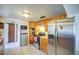 Compact kitchen featuring a range and stainless-steel refrigerator, with a view of a pantry at 1849 E Jarvis Ave, Mesa, AZ 85204