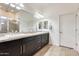Bright bathroom with double vanity sinks, modern lighting, and a large mirror at 20017 S 192Nd Pl, Queen Creek, AZ 85142