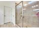 Bathroom featuring tiled walk-in shower, tiled floors, and white door at 20017 S 192Nd Pl, Queen Creek, AZ 85142