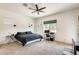 Large bedroom featuring a ceiling fan, desk, tv and great natural light at 20017 S 192Nd Pl, Queen Creek, AZ 85142
