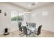 Bright dining room with a glass table, stylish chandelier, and large window at 20017 S 192Nd Pl, Queen Creek, AZ 85142