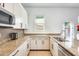 Bright kitchen features granite counters, stainless steel appliances, and white cabinets with dark hardware at 20017 S 192Nd Pl, Queen Creek, AZ 85142