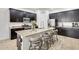 Modern kitchen featuring dark cabinetry, granite countertops, stainless steel appliances, and a large center island at 20017 S 192Nd Pl, Queen Creek, AZ 85142