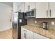 Modern kitchen with stainless steel appliances, granite counters, and sleek white cabinetry for a stylish design at 20017 S 192Nd Pl, Queen Creek, AZ 85142