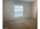 Bright bedroom featuring neutral carpet and natural light streaming through the window at 2028 E Libby St, Phoenix, AZ 85022