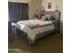 Comfortable bedroom featuring a bed with a gray comforter and a side table at 2028 E Libby St, Phoenix, AZ 85022