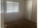 Neat bedroom with a window bringing in natural light, complemented by wood flooring at 2028 E Libby St, Phoenix, AZ 85022