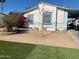 Charming home featuring low-maintenance desert landscaping with a colorful bush and a quaint tree in the front yard at 2028 E Libby St, Phoenix, AZ 85022