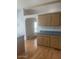 Kitchen showcasing wood cabinets, laminate countertops, and an adjacent space, offering functionality and room for customization at 2028 E Libby St, Phoenix, AZ 85022