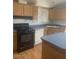 Kitchen with wood cabinets, dark countertops, and modern appliances including a black oven, offering both style and practicality at 2028 E Libby St, Phoenix, AZ 85022
