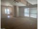 Spacious carpeted living room with vaulted ceilings, featuring an open layout and plenty of natural light from the windows at 2028 E Libby St, Phoenix, AZ 85022