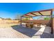 Large backyard with brick pavers, desert landscaping, and covered patio; perfect for entertaining at 2031 S 86Th Ln, Tolleson, AZ 85353