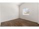 Simple bedroom with hardwood floors and a single window providing natural light at 2031 S 86Th Ln, Tolleson, AZ 85353