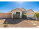 Single-story home with desert landscaping, block wall and a two-car garage at 2031 S 86Th Ln, Tolleson, AZ 85353
