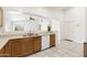 Bright kitchen featuring wooden cabinets, white appliances, tile floors, and ample counter space at 2031 S 86Th Ln, Tolleson, AZ 85353