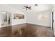 Living room with laminate flooring, ceiling fan, and view to the kitchen at 2031 S 86Th Ln, Tolleson, AZ 85353
