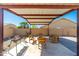 Covered patio with space for grilling and relaxing with pavers and desert landscaping at 2031 S 86Th Ln, Tolleson, AZ 85353