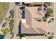 A stunning aerial view showcases the tile roof and landscaped backyard of this home at 20609 N Canyon Whisper Dr, Surprise, AZ 85387