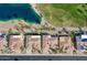 Aerial view of a home with a red star on the roof, landscaped yard, and a community lake with lush landscaping at 20609 N Canyon Whisper Dr, Surprise, AZ 85387