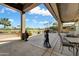 Spacious covered back patio with golf course views and built-in grill, perfect for outdoor entertaining at 20609 N Canyon Whisper Dr, Surprise, AZ 85387
