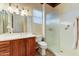 Bathroom featuring cherry wood cabinets, neutral walls, and a glass-enclosed shower at 20609 N Canyon Whisper Dr, Surprise, AZ 85387