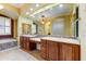 Luxurious bathroom featuring dual vanities, a mosaic tile backsplash, and soaking tub at 20609 N Canyon Whisper Dr, Surprise, AZ 85387