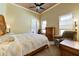 Inviting bedroom features a comfy chair, ceiling fan, and neutral walls at 20609 N Canyon Whisper Dr, Surprise, AZ 85387