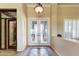 Elegant foyer features decorative tile flooring, double glass doors, and custom glasswork at 20609 N Canyon Whisper Dr, Surprise, AZ 85387