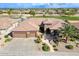 Beautiful desert landscaping surrounds this home featuring a three-car garage at 20609 N Canyon Whisper Dr, Surprise, AZ 85387