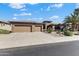 Attractive single-story home showcasing manicured landscaping and a convenient three-car garage at 20609 N Canyon Whisper Dr, Surprise, AZ 85387