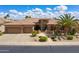 Beautiful single-story home showcasing manicured landscaping, a spacious three-car garage, and gated entry at 20609 N Canyon Whisper Dr, Surprise, AZ 85387