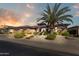 A well-manicured front yard and three car garage enhance this inviting home at 20609 N Canyon Whisper Dr, Surprise, AZ 85387