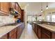 Gourmet kitchen with sleek countertops, stainless steel appliances, and a seamless flow to the living area at 20609 N Canyon Whisper Dr, Surprise, AZ 85387