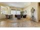 Bright and airy living room featuring neutral tones, plantation shutters, and comfortable seating at 20609 N Canyon Whisper Dr, Surprise, AZ 85387